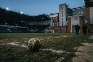 Footballers in prison concept showing football and the criminal justice system